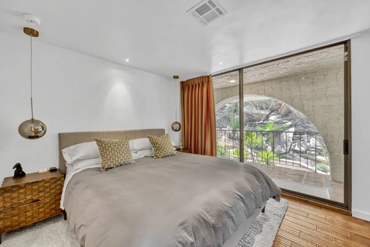 The Garden En-Suite bedroom, with sliding glass doors onto the boulder garden.